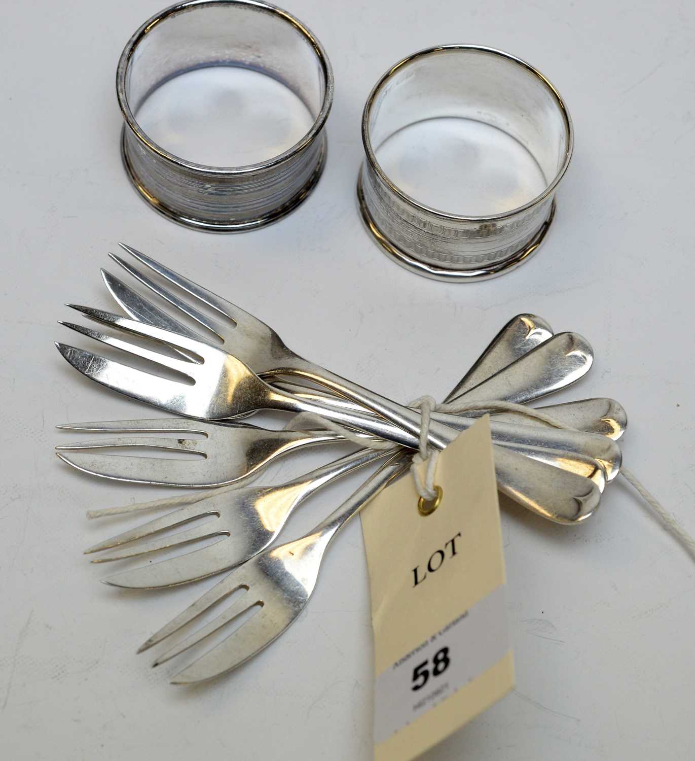 A set of six George V silver cake forks and two napkin rings.