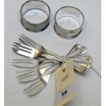 A set of six George V silver cake forks and two napkin rings.