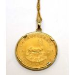 A 1980 gold quarter Krugerrand held in a 9ct gold pendant mount.