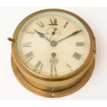 A ship's clock by Cooke,