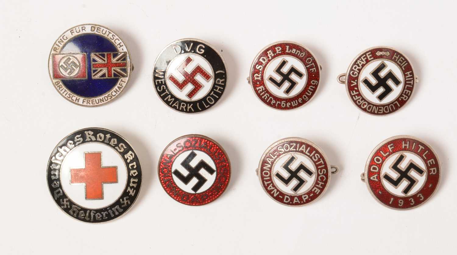 A collection of WWII enamel lapel badges