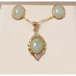 A 9ct gold, diamond and jade coloured stone pendant necklace and earring set.