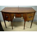 A Regency bowfront mahogany sideboard.