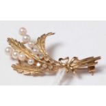 A 9ct gold, diamond, and pearl floral spray brooch.