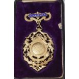 A cased George V silver jewel or medallion