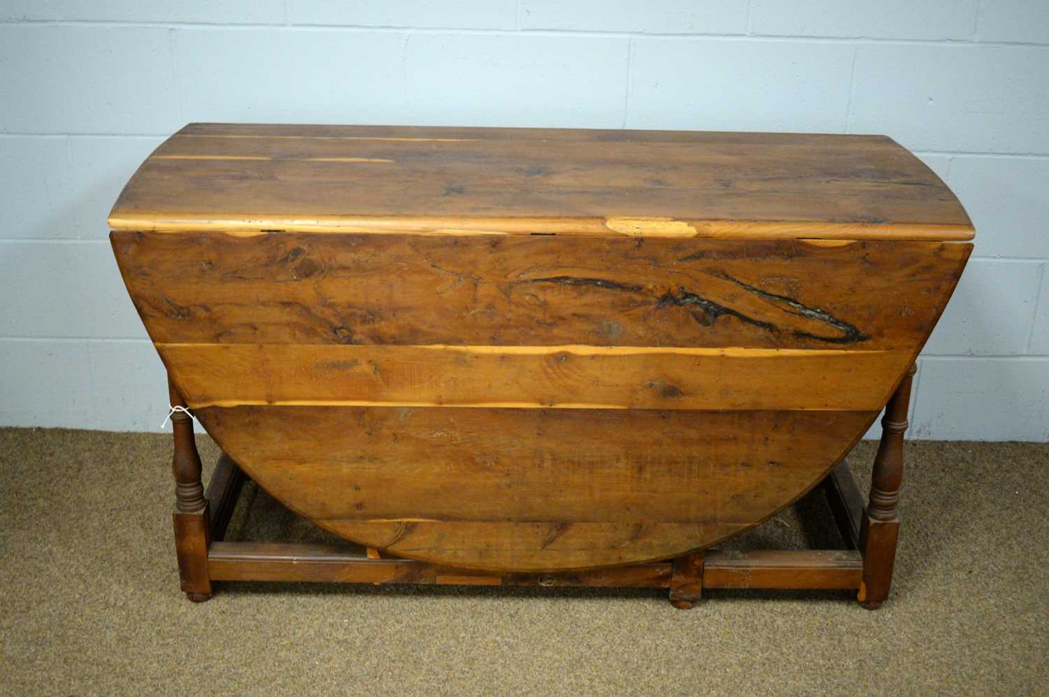 A 20th Century yew wood drop leaf dining table.