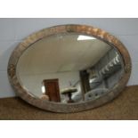 A 20th Century oval wall mirror.