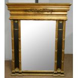 A 20th Century black painted and gilt overmantel mirror.