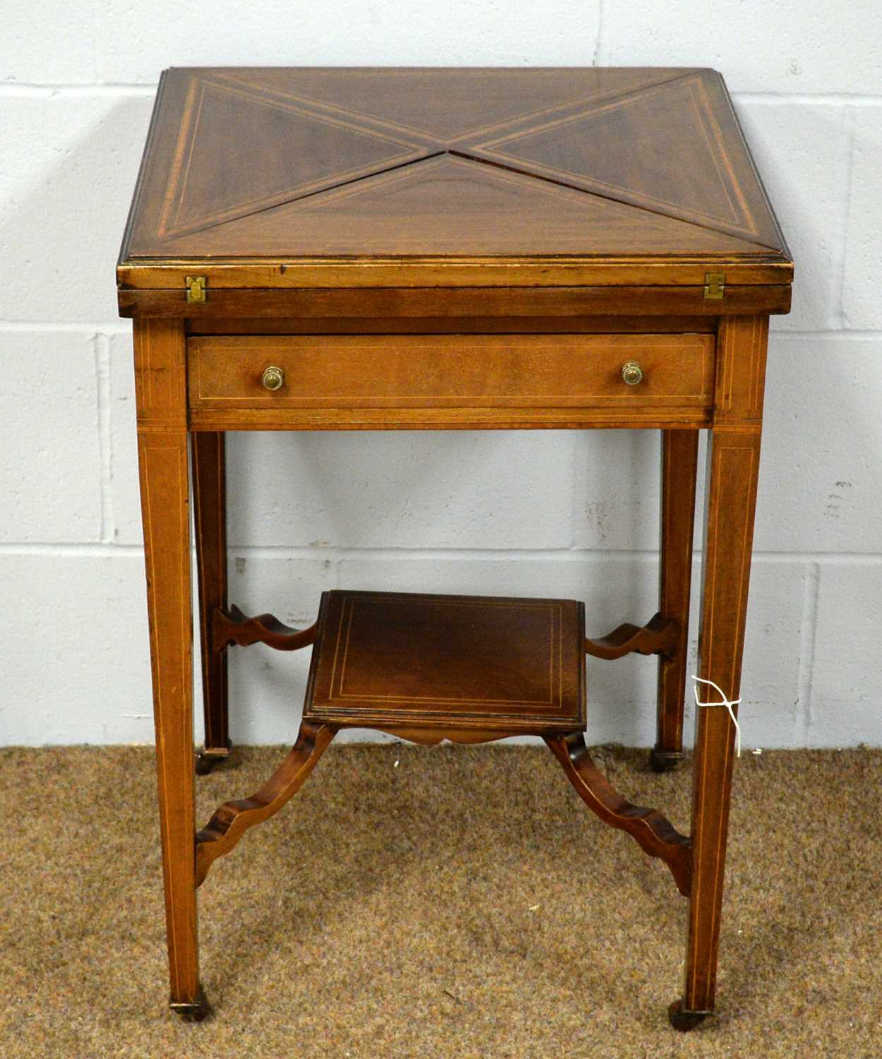 An Edwardian mahogany envelope card table.