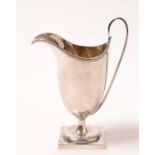 A George V silver pedestal cream jug.