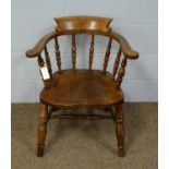 A late 19th Century elm captain's chair.