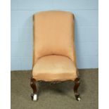 A late Victorian walnut slipper chair, upholstered in peach fabric.