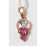A contemporary yellow-metal ruby and diamond pendant.