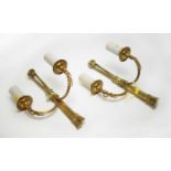 A pair of gilt metal two-branch wall brackets