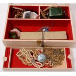 A jewellery box containing a quantity of costume jewellery.