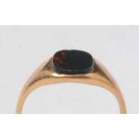 A yellow-metal and bloodstone signet ring.