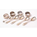 Antique silver spoons and napkin rings.