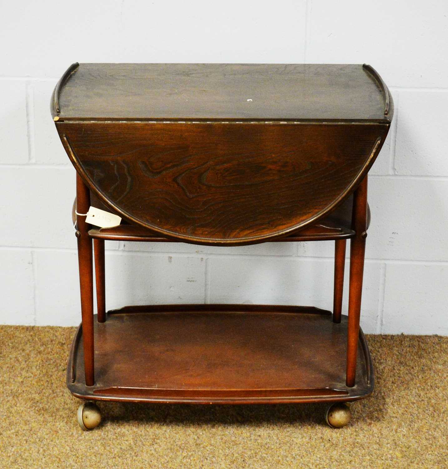 A 20th Century Ercol elm three-tier drinks trolley.