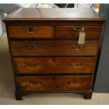 A late George III oak chest of drawers.
