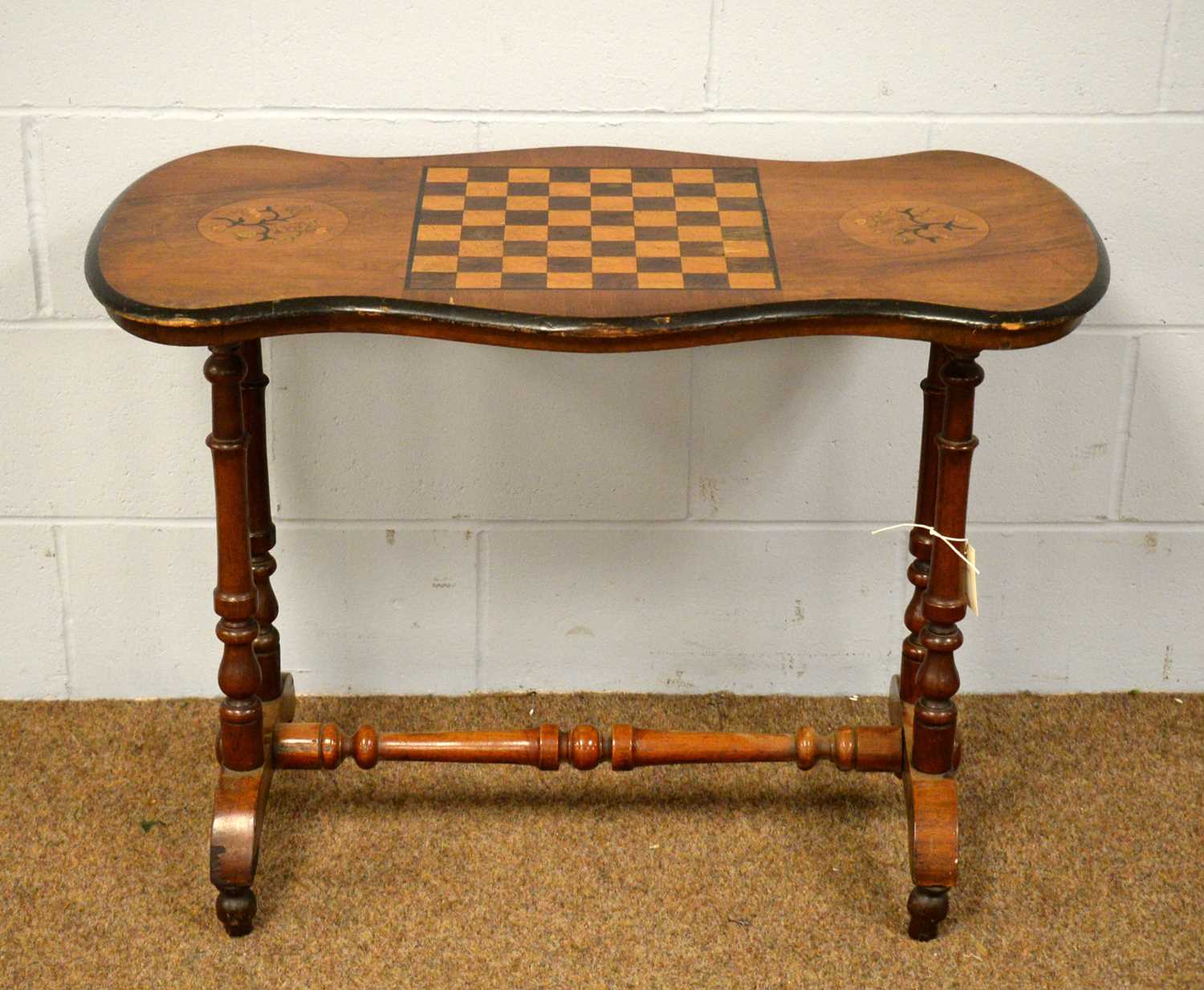 A Victorian walnut and inlaid games table