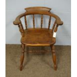 A 20th Century yew wood captain's chair.