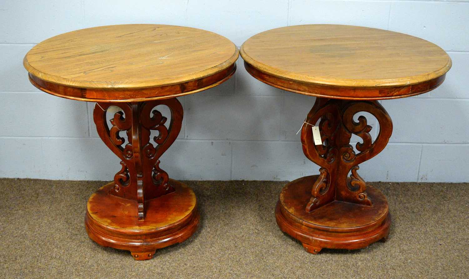 A pair of 20th Century elm circular tables.