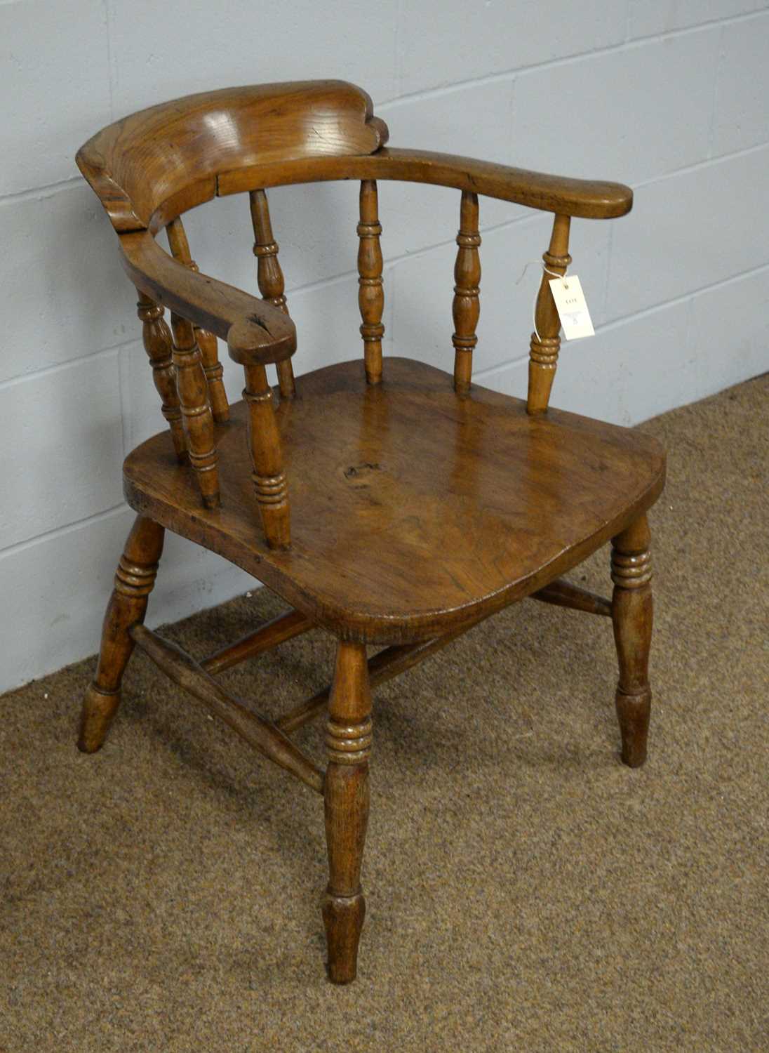 An early 20th Century elm captain's chair. - Image 2 of 2