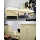 Ornate French-style cream and gilt-painted bedroom furniture.