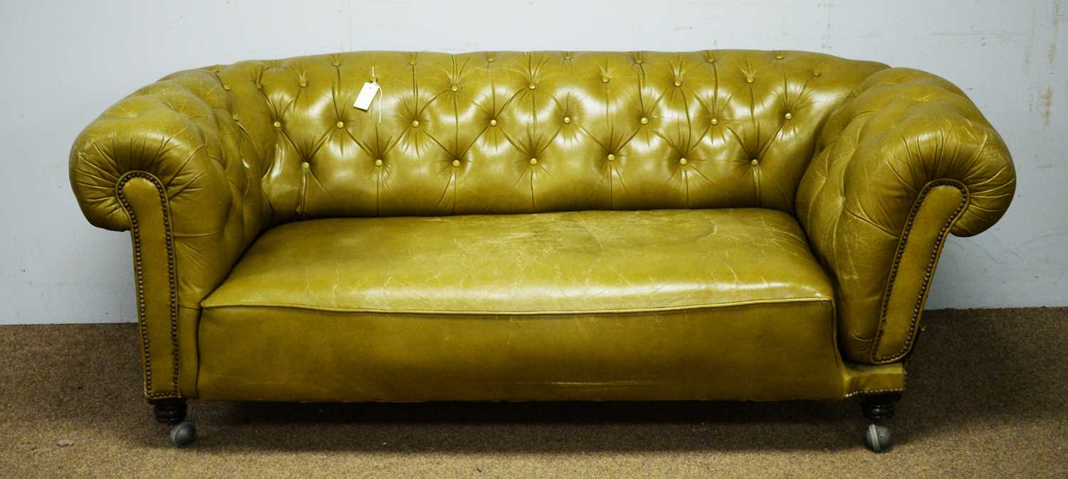A late Victorian green buttoned and studded leather drop-end Chesterfield sofa.