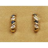 A pair of diamond and blue stone earring