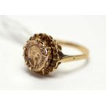A yellow metal coin set ring,