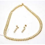 A cultured pearl and yellow metal bead necklace,