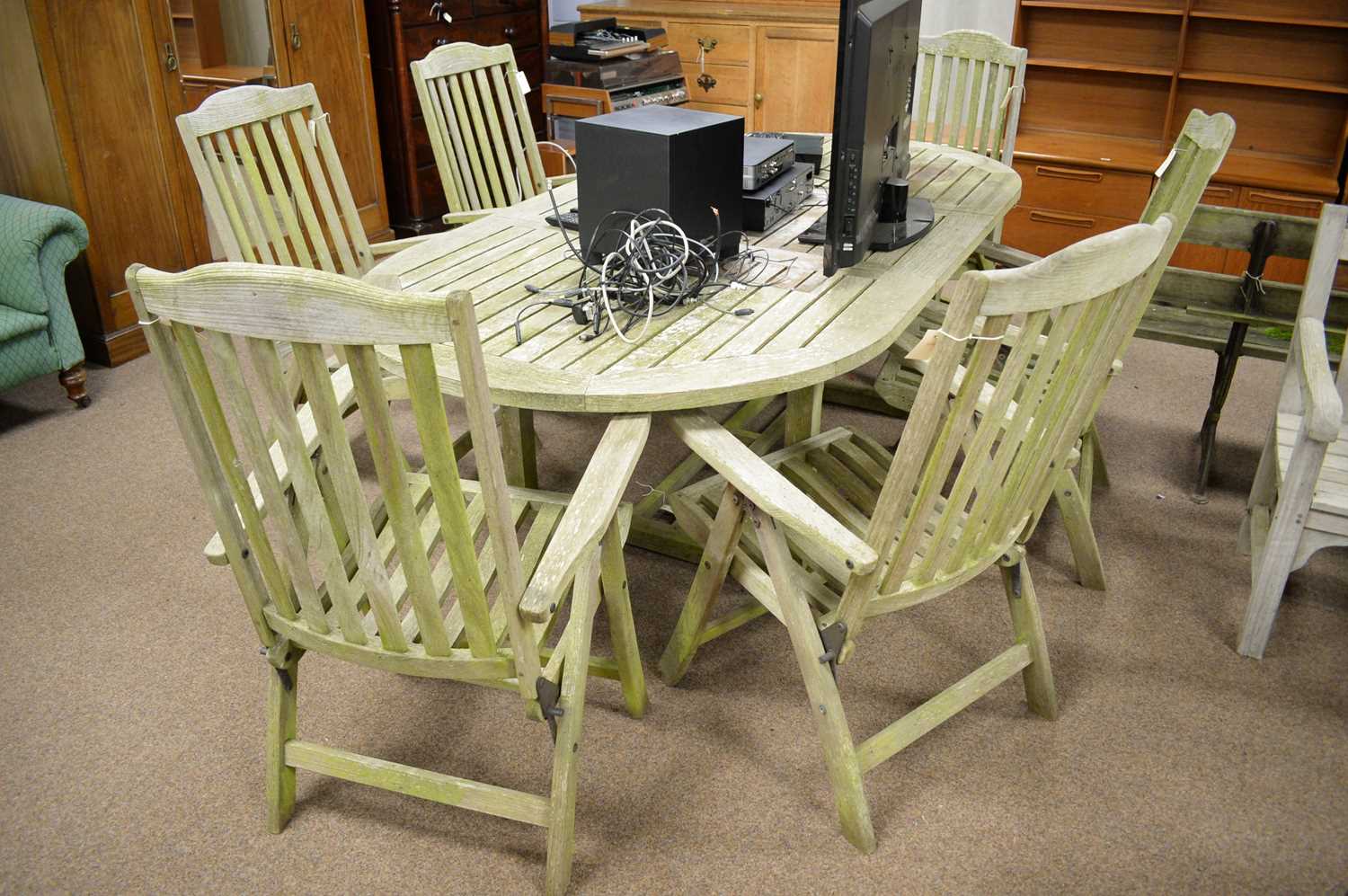 A substantial modern teak garden table and six chairs, probably by Indian Ocean Trading Co