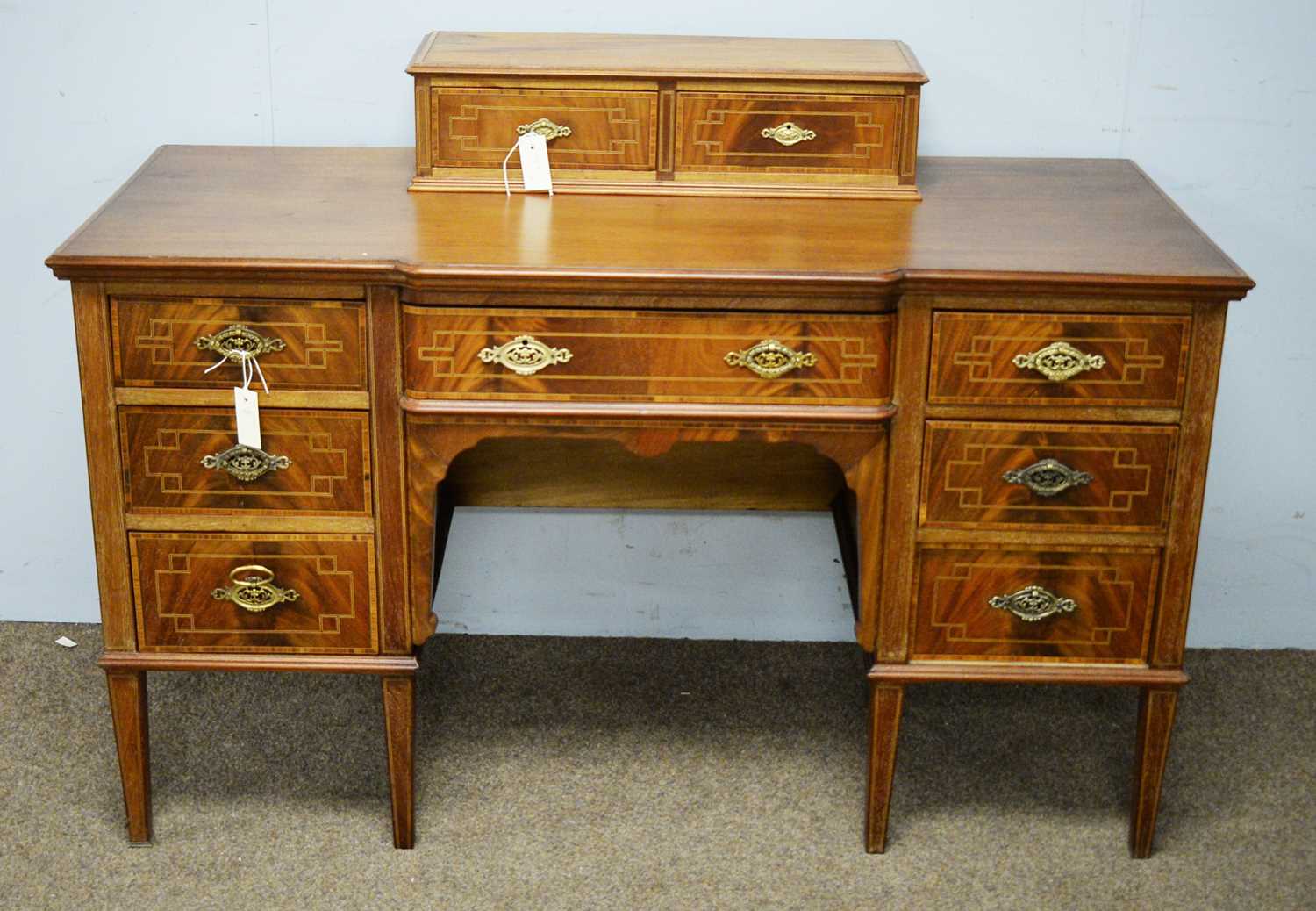 An inlaid mahogany breakfront dressing table base.