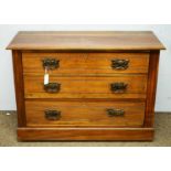 An Edwardian walnut three drawer chest.