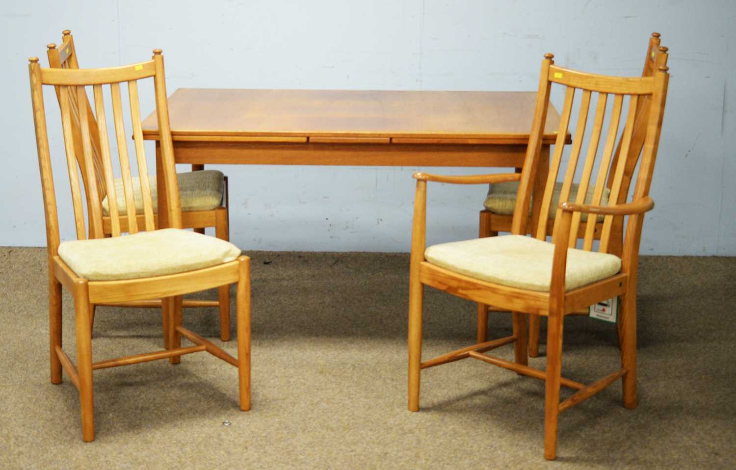 A Troeds teak extending dining table; set of four Ercol dining chairs; and a single 'Siesta' chair.