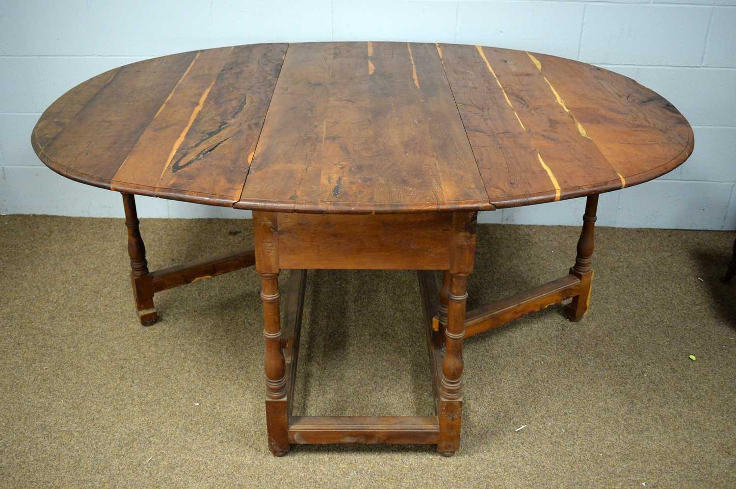 A 20th Century yew wood drop leaf dining table. - Image 2 of 2