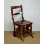 A reproduction mahogany metamorphic library chair/steps.