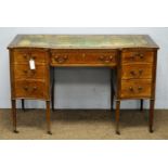 An Edwardian inlaid mahogany breakfront desk.