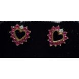 A pair of ruby and diamond heart shaped stud earrings,