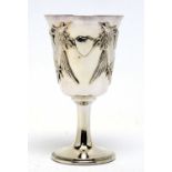 A white metal goblet or chalice