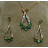 An emerald and diamond pendant with matching earrings,