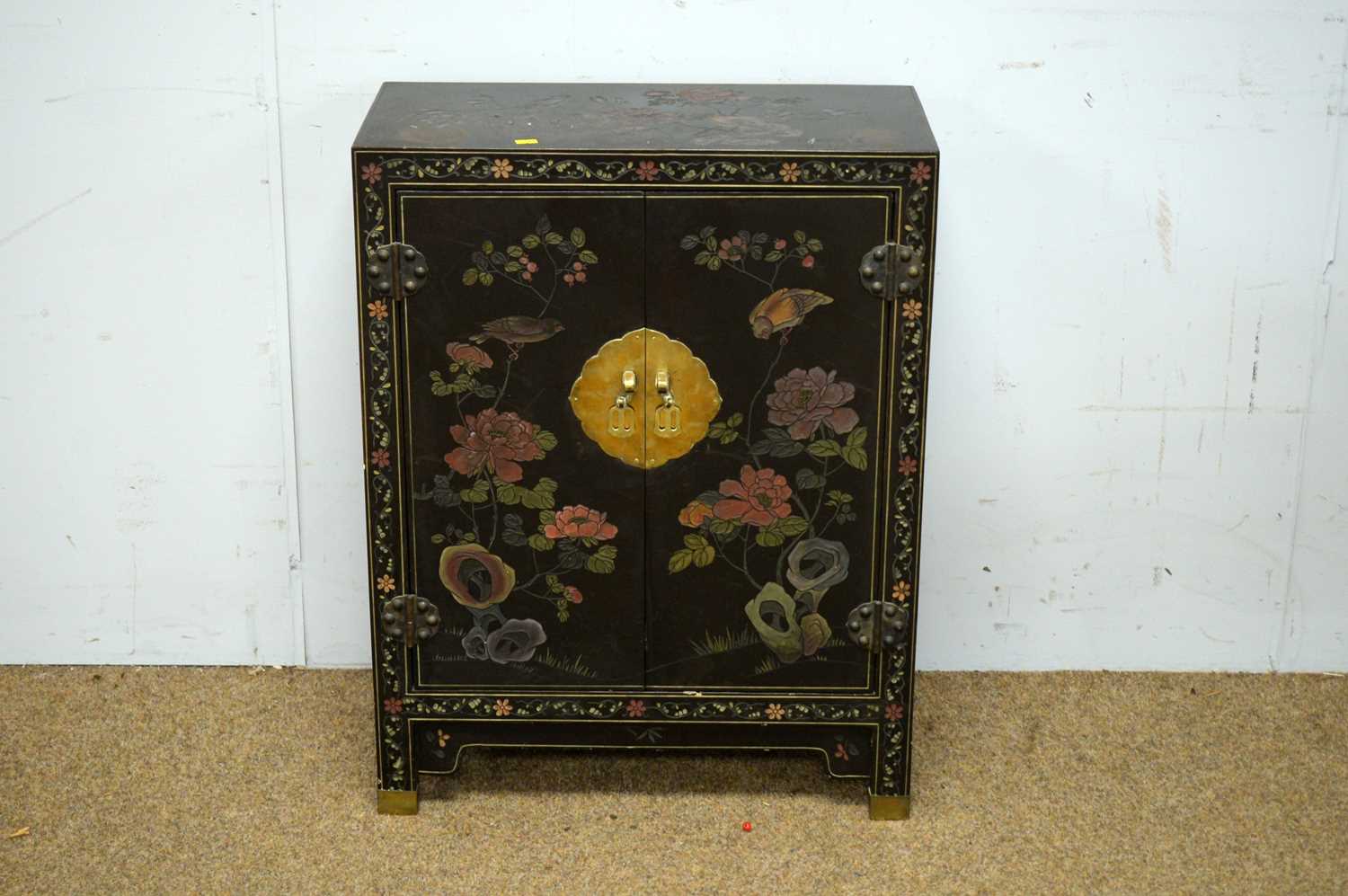 An Asian black lacquered two door cabinet.