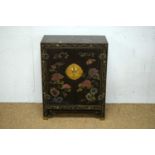 An Asian black lacquered two door cabinet.