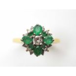 An emerald and diamond ring