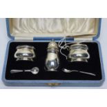 A silver condiment set,