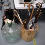 Selection of walking canes, parasol and a carboy