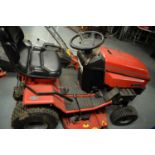 A Westwood T1600 ride-on petrol lawn mower and accessories.