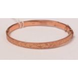 An antique 9ct rose gold hinged bangle