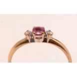 A contemporary three-stone ruby and diamond ring.